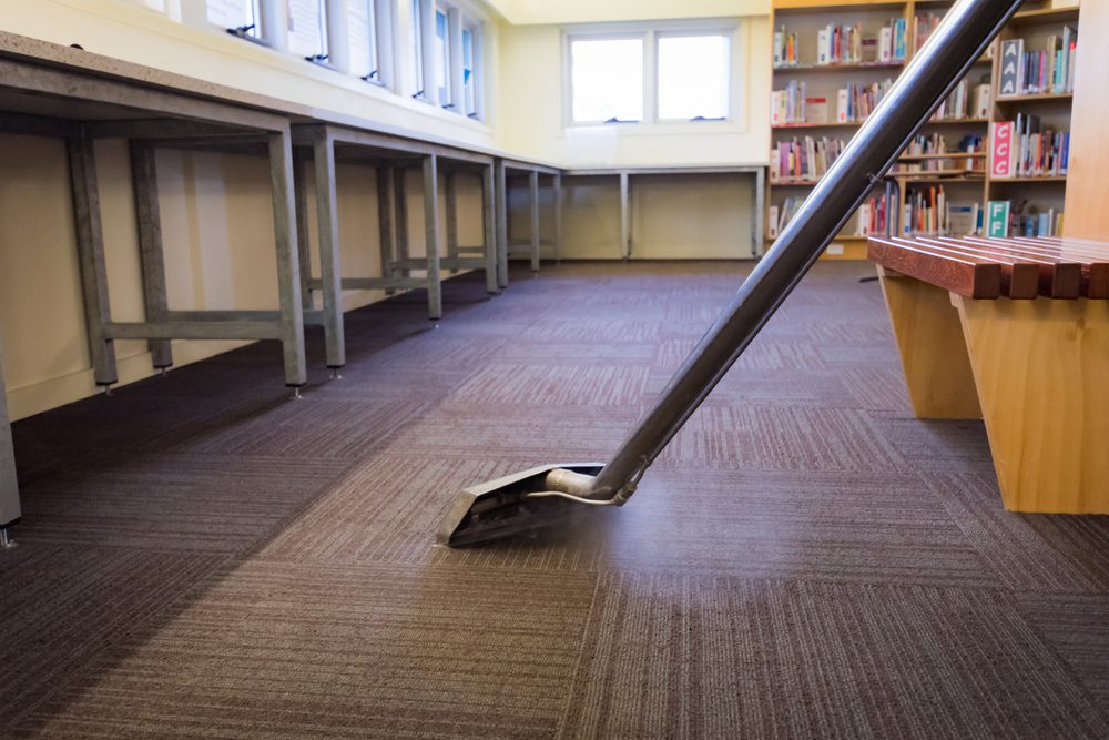 A carpet cleaning machine in the middle of an empty library.